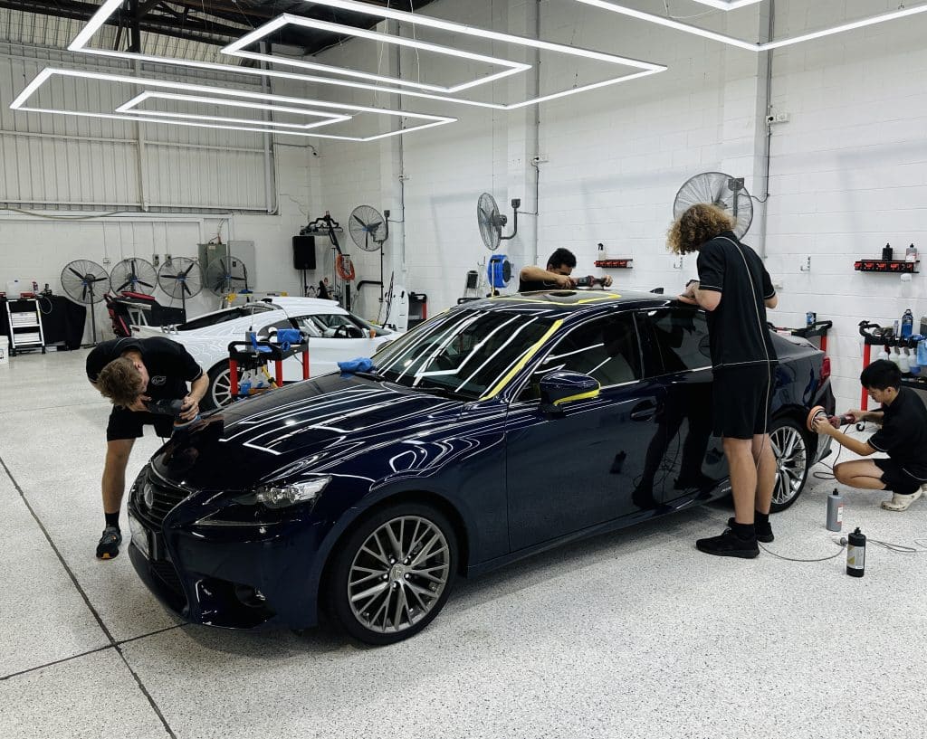 car getting polish in detailing shop