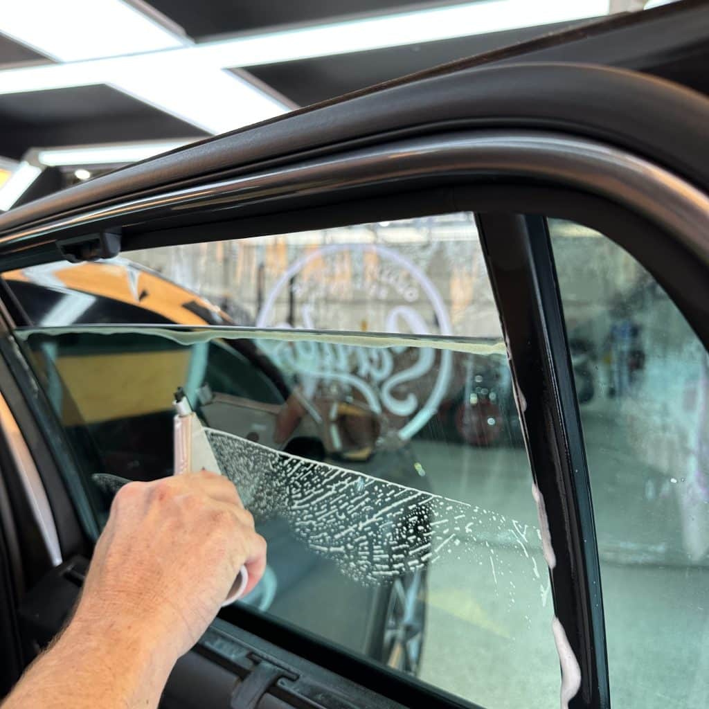 car getting window tinting in workshop