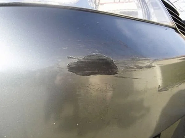 A close up of a vehicle with paint missing